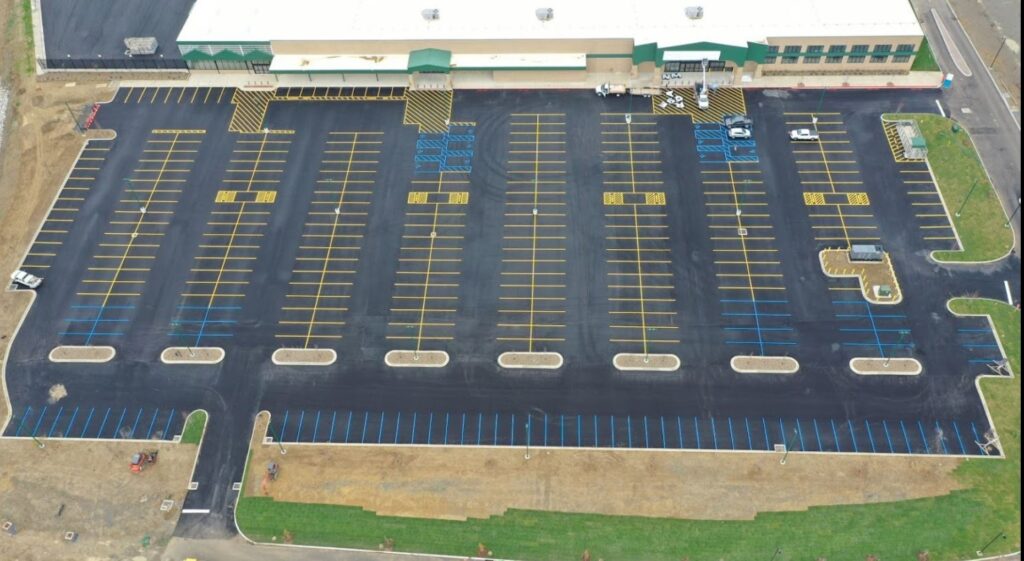 The newly painted lines in the brand new asphalt parking lot of a home improvement box store