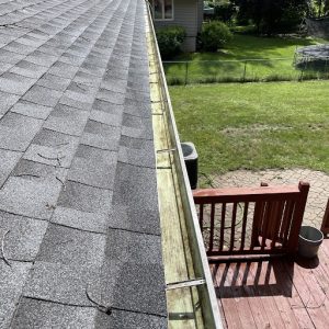 Result of professional gutter cleaning services on a residential property ensuring proper drainage.