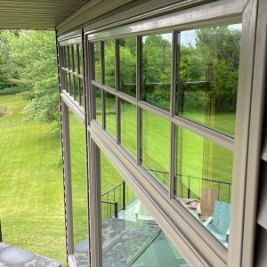 A spacious patio featuring a large window that offers a scenic view of the outdoors.